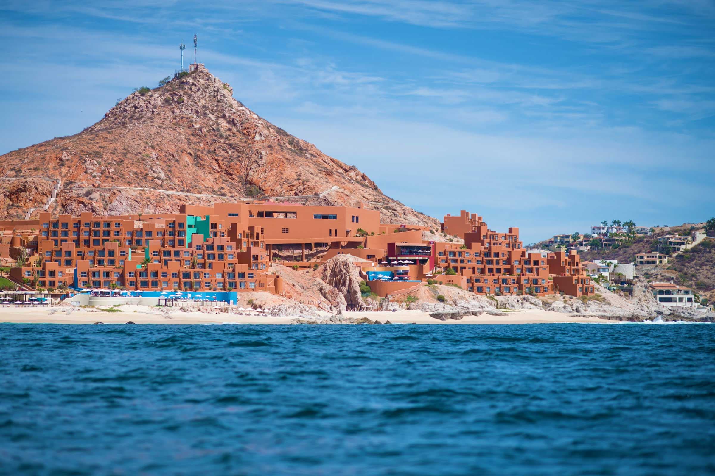 facade-of-club-regina-los-cabos-at-night-in-front-of-the-pool-and-the-ocean